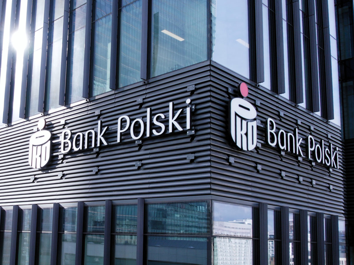 PKO Bank Polski signage on the corner of a modern office building facade.