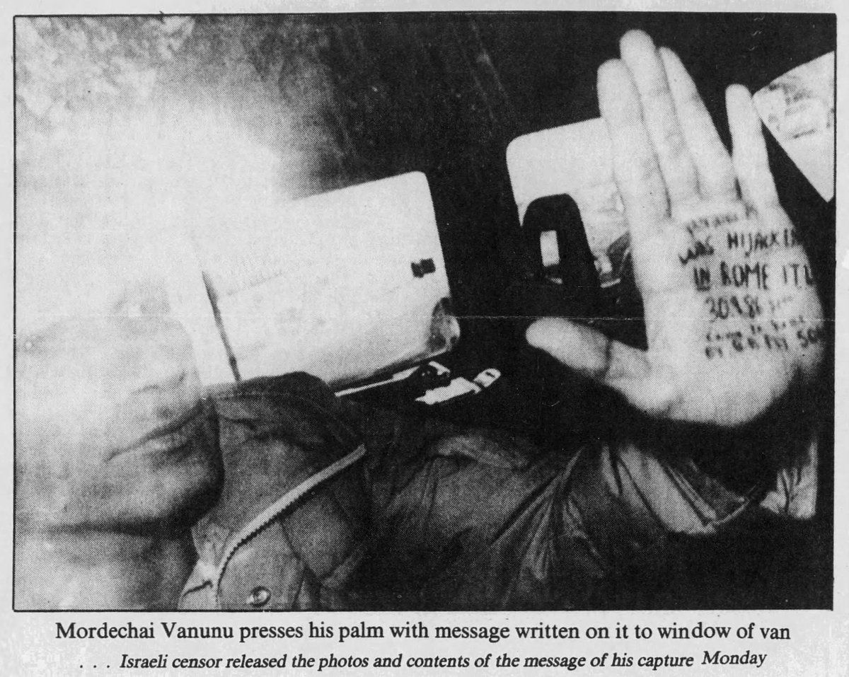 Archival newspaper photograph of Mordechai Vanunu pressing his palm, with a handwritten message, against the window of a van.
