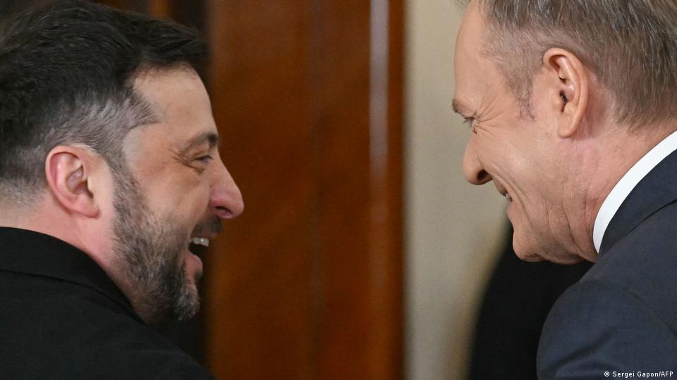 Volodymyr Zelensky and Donald Tusk speaking together.